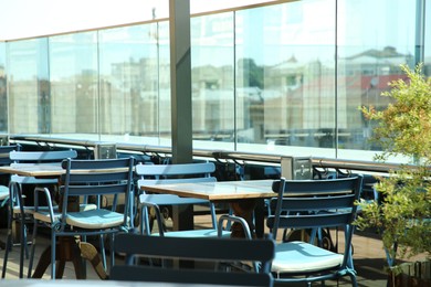 Observation area cafe. Tables, chairs and plant against beautiful cityscape