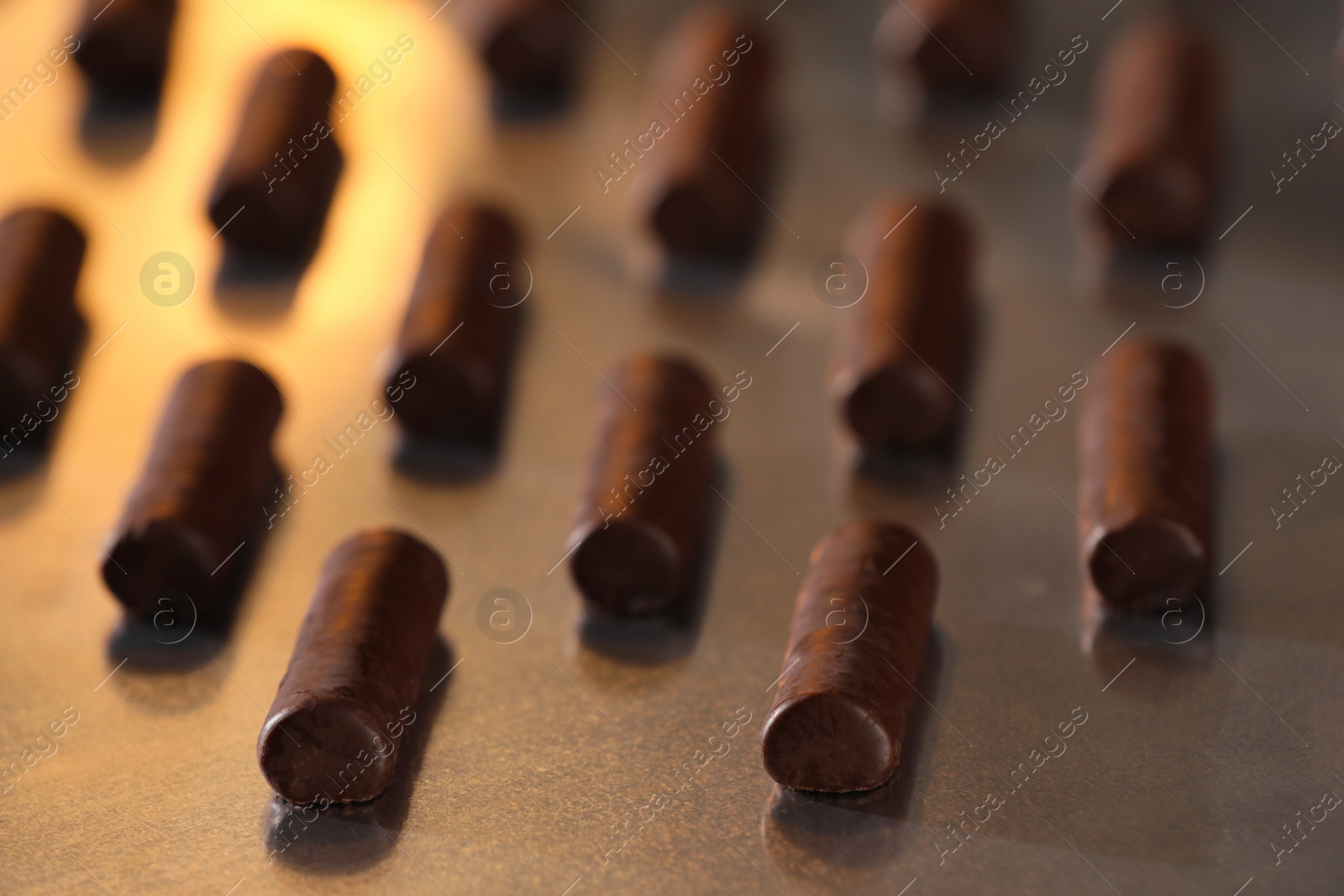 Photo of Many delicious chocolate candies on table, closeup. Production line