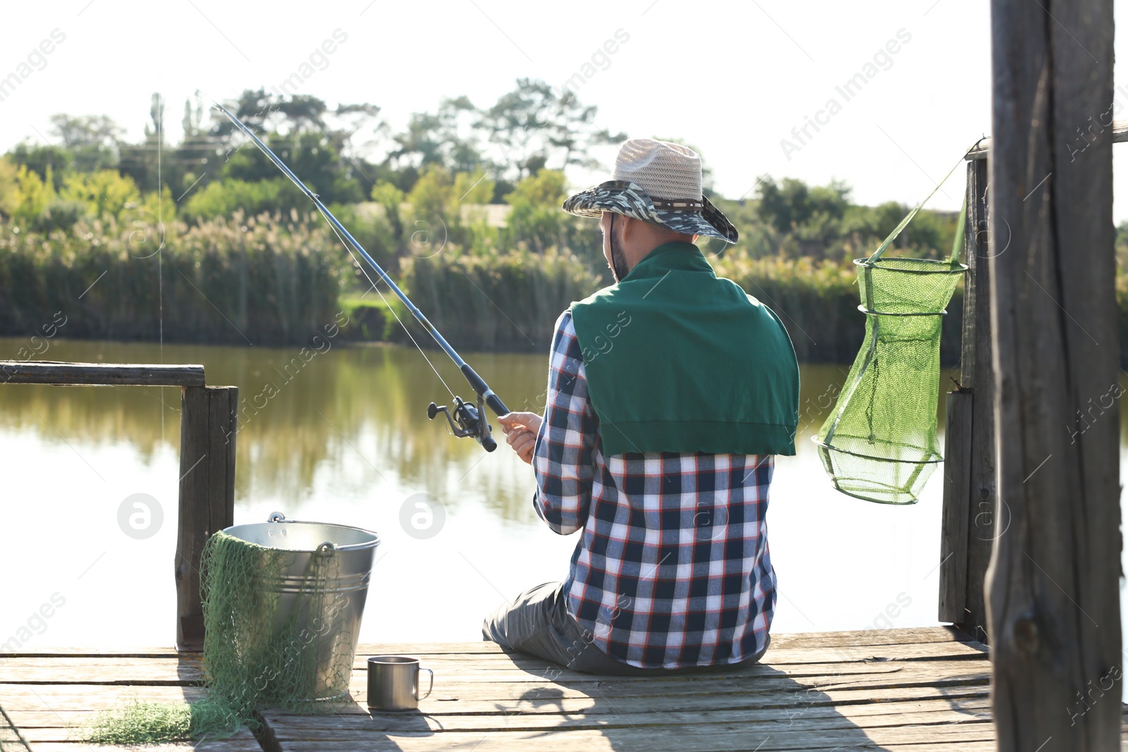 Photo of Young man fishing alone on sunny day