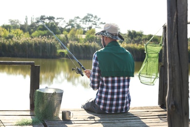 Photo of Young man fishing alone on sunny day