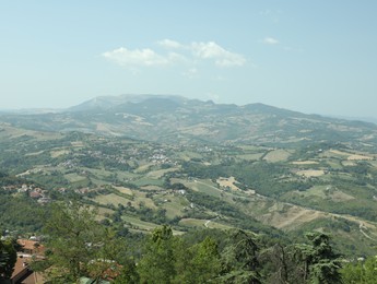 Aerial view of countryside and mountains on sunny day