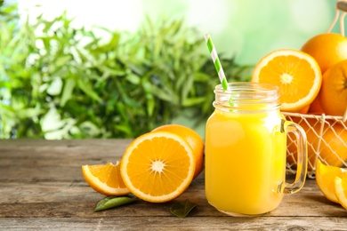 Photo of Composition with orange juice and fresh fruit on table, space for text