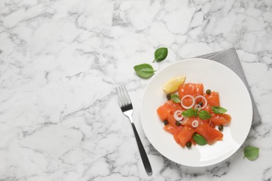 Photo of Delicious salmon carpaccio served on white marble table, flat lay. Space for text