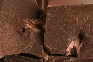 Pieces of dark chocolate as background, closeup