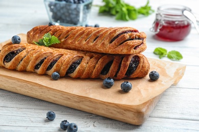 Fresh delicious puff pastry with sweet berries served on white wooden table