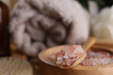 Photo of Pink sea salt for spa on blurred background, closeup. Space for text