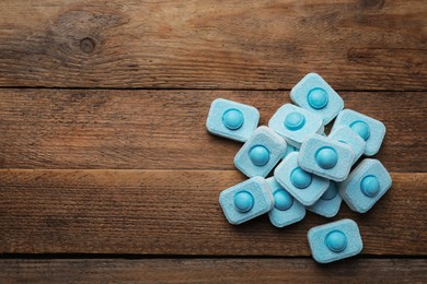 Water softener tablets on wooden table, flat lay. Space for text