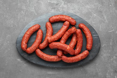 Photo of Delicious sausages on grey table, top view