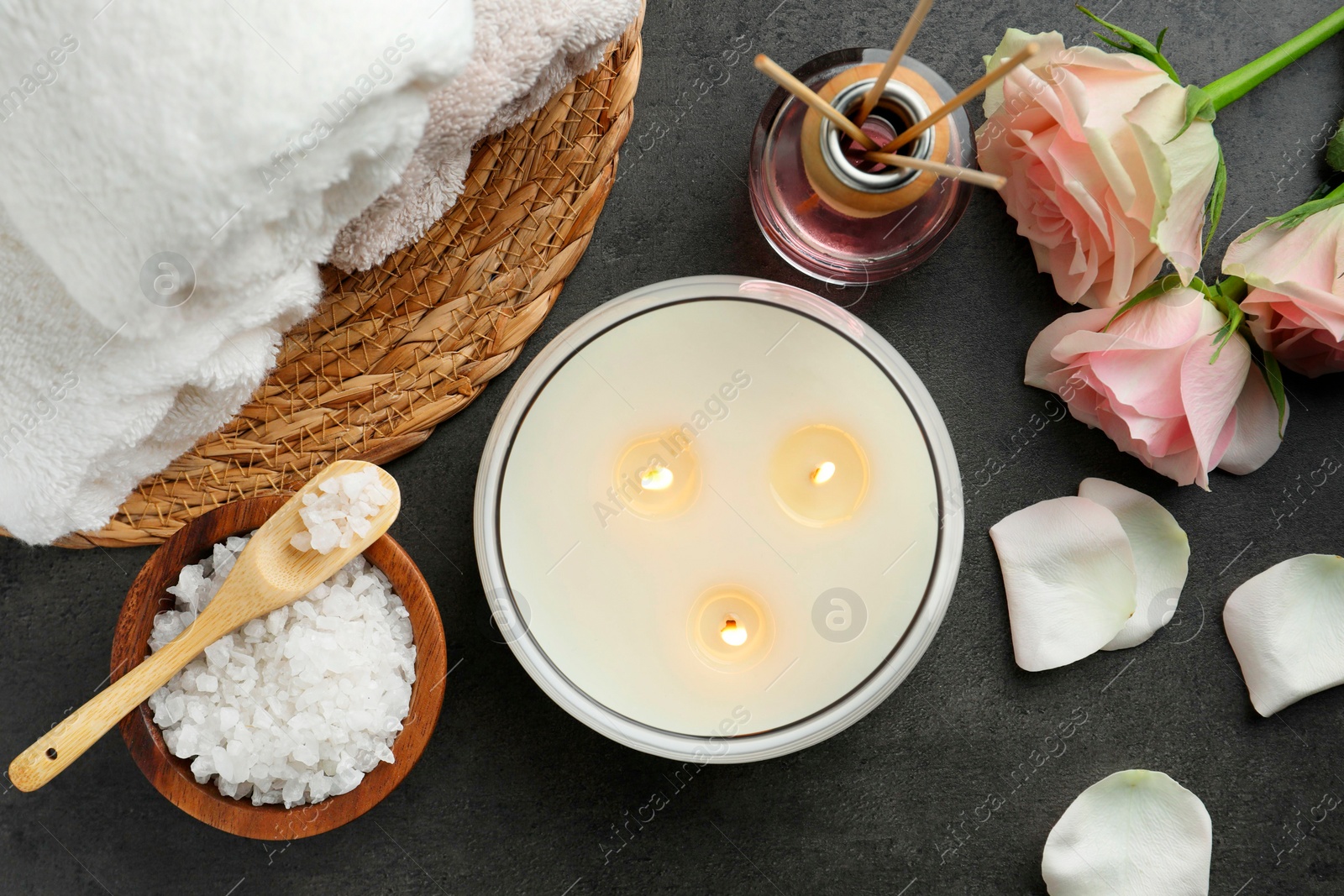 Photo of Flat lay composition with different spa products and rose flowers on grey table