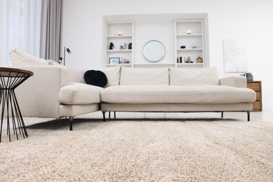 Photo of Fluffy carpet and stylish furniture on floor indoors