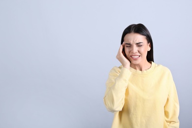 Photo of Portrait of stressed young woman on grey background. Space for text