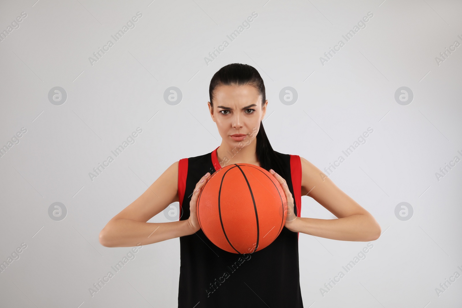 Photo of Basketball player with ball on grey background