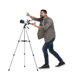 Excited astronomer with telescope pointing at something on white background