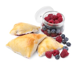 Photo of Delicious samosas with berries isolated on white