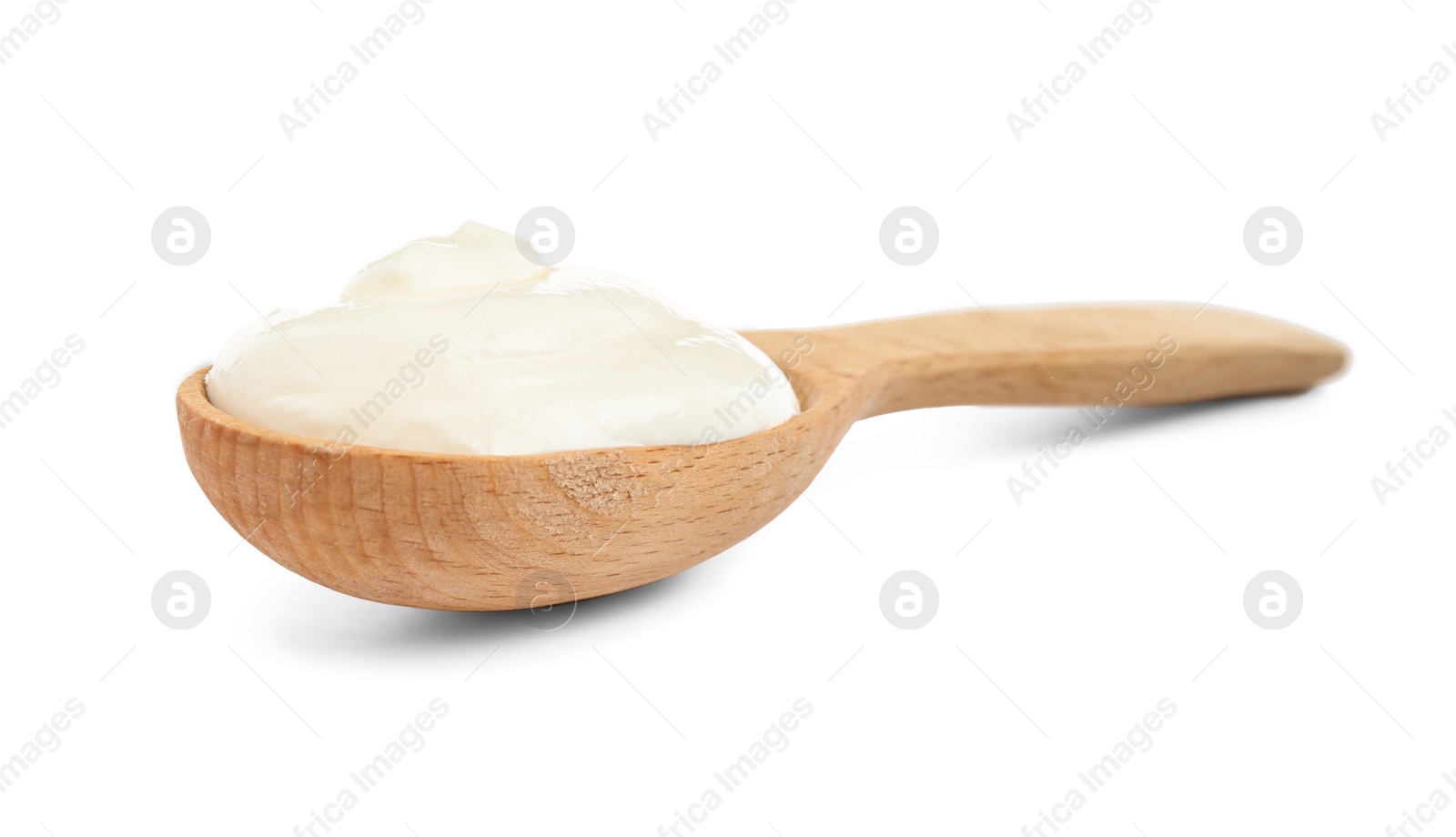 Photo of Wooden spoon with sour cream on white background