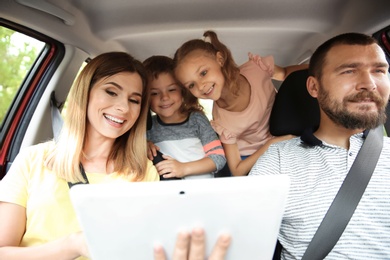 Photo of Happy family with children taking road trip together