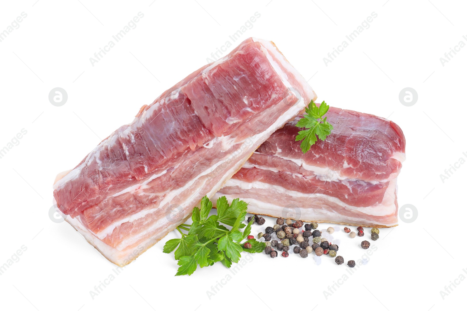 Photo of Pieces of raw pork belly, peppercorns and parsley isolated on white