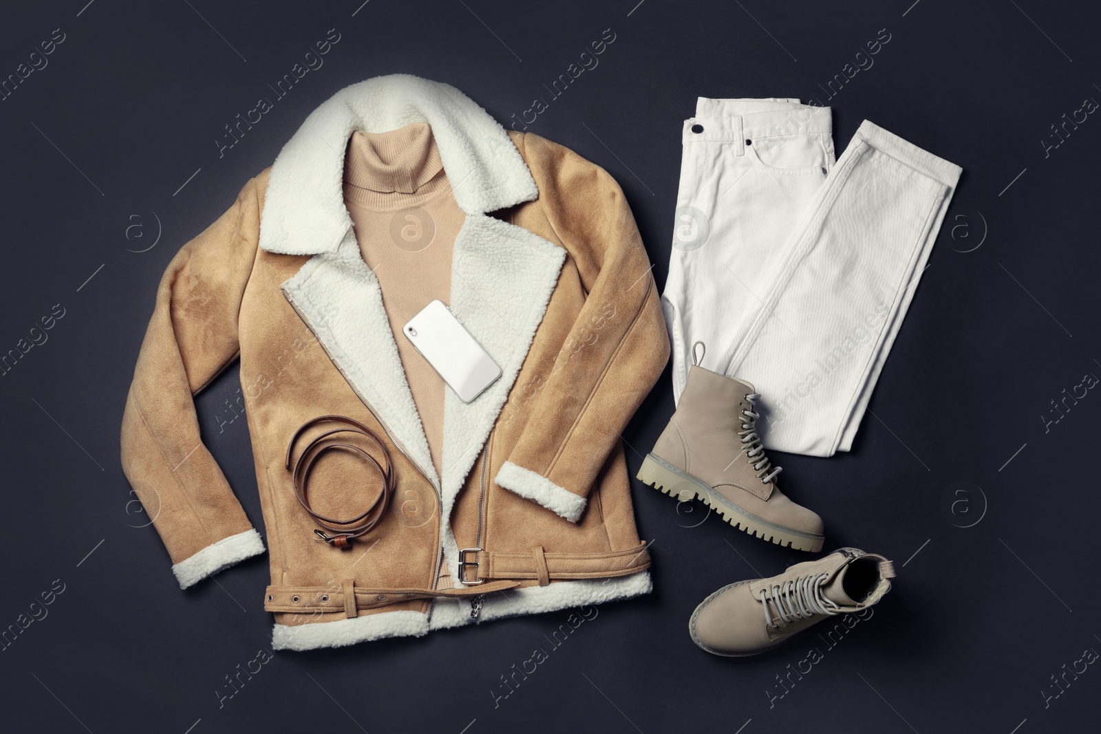 Photo of Stylish boots, new clothes, smartphone and accessories on black background, flat lay