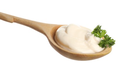 Photo of Wooden spoon with tasty mayonnaise and parsley isolated on white