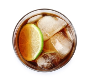 Photo of Glass of cocktail with cola, ice and cut lime on white background, top view