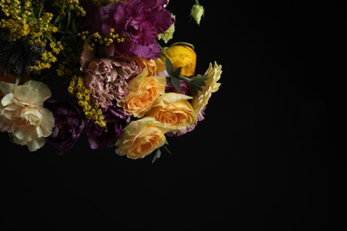 Photo of Beautiful fresh flowers on dark background, space for text