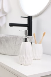 Photo of Different bath accessories and personal care products on bathroom vanity indoors, closeup