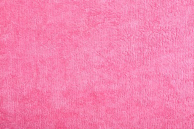 Pink microfiber cloth as background, top view