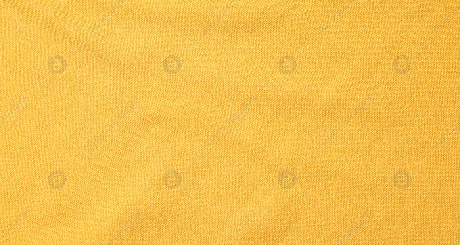 Photo of Texture of soft yellow fabric as background, top view