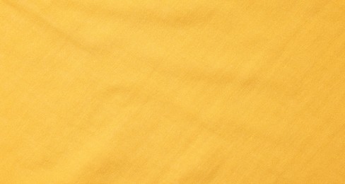 Texture of soft yellow fabric as background, top view