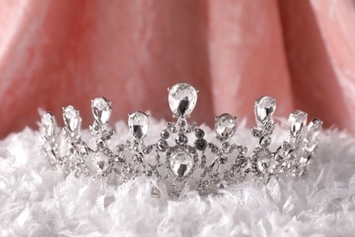 Beautiful silver tiara with diamonds on white soft cloth