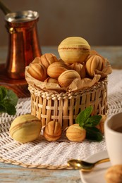 Photo of Walnut shaped cookies and mint on table. Homemade pastry filled with caramelized condensed milk