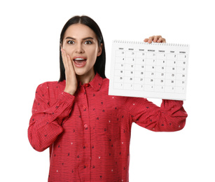 Surprised young woman holding calendar with marked menstrual cycle days on white background