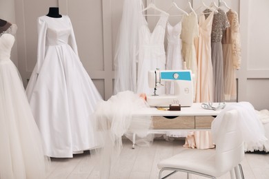 Photo of Dressmaking workshop interior with wedding dresses and equipment