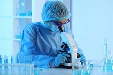 Scientist working with microscope in laboratory. Medical research