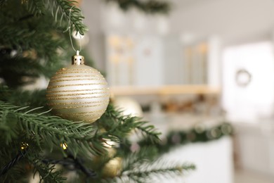 Closeup view of beautiful decorated Christmas tree in kitchen. Space for text