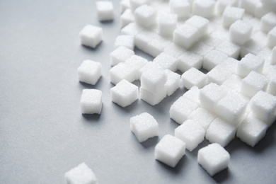 Refined sugar cubes on grey background