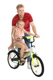 Photo of Young father teaching daughter to ride bicycle on white background