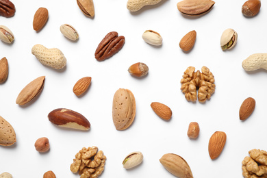 Photo of Different delicious nuts on white background, flat lay