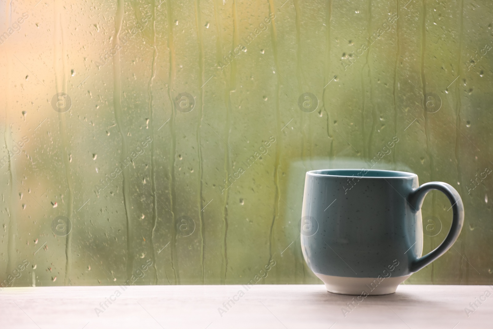 Photo of Cup of drink on windowsill, space for text. Rainy weather