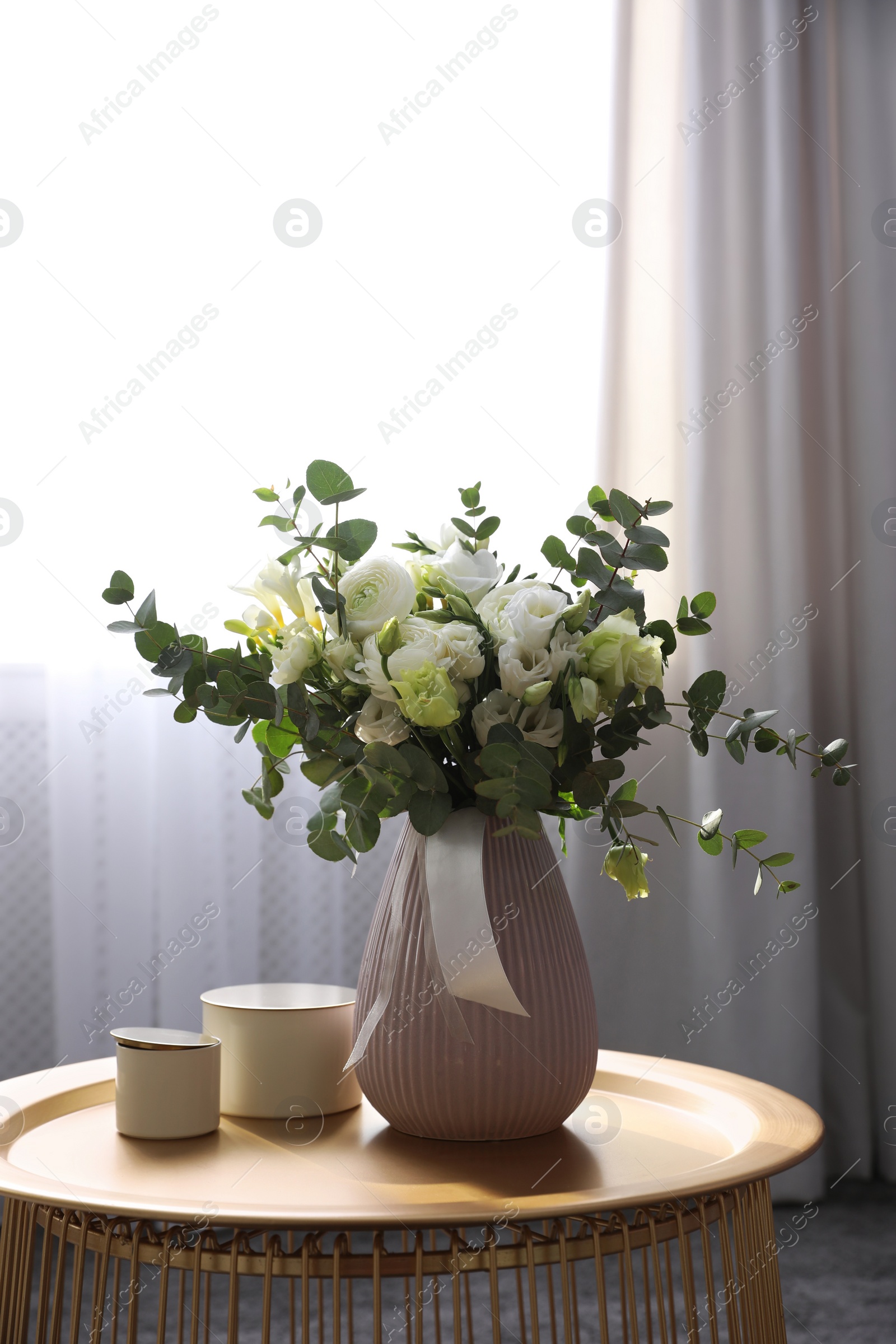 Photo of Beautiful bouquet of flowers on table in room. Stylish interior design