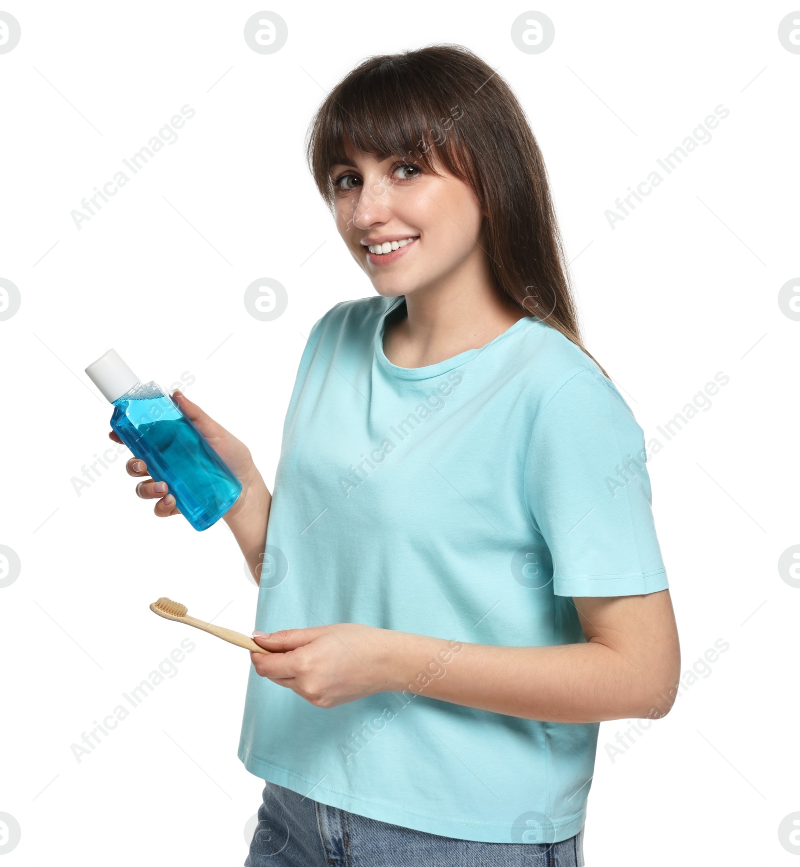 Photo of Young woman with mouthwash and toothbrush on white background