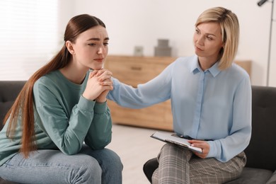 Photo of Professional psychotherapist working with patient in office