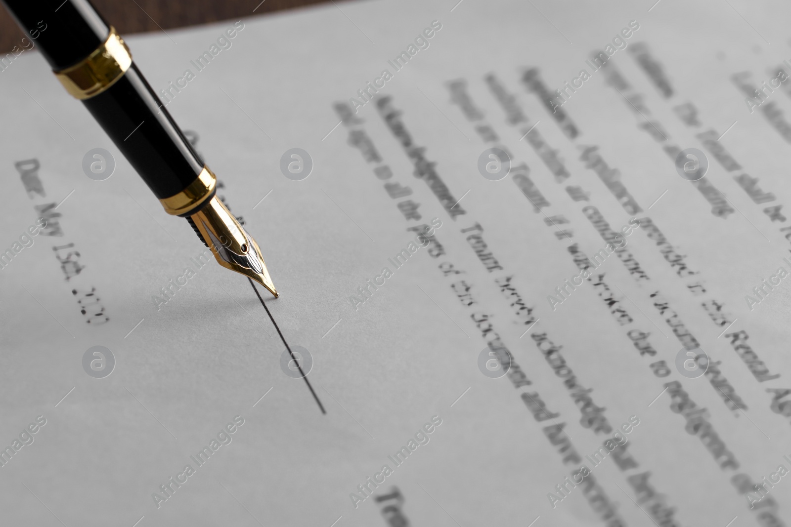 Photo of Writing on document with fountain pen, closeup. Notary contract