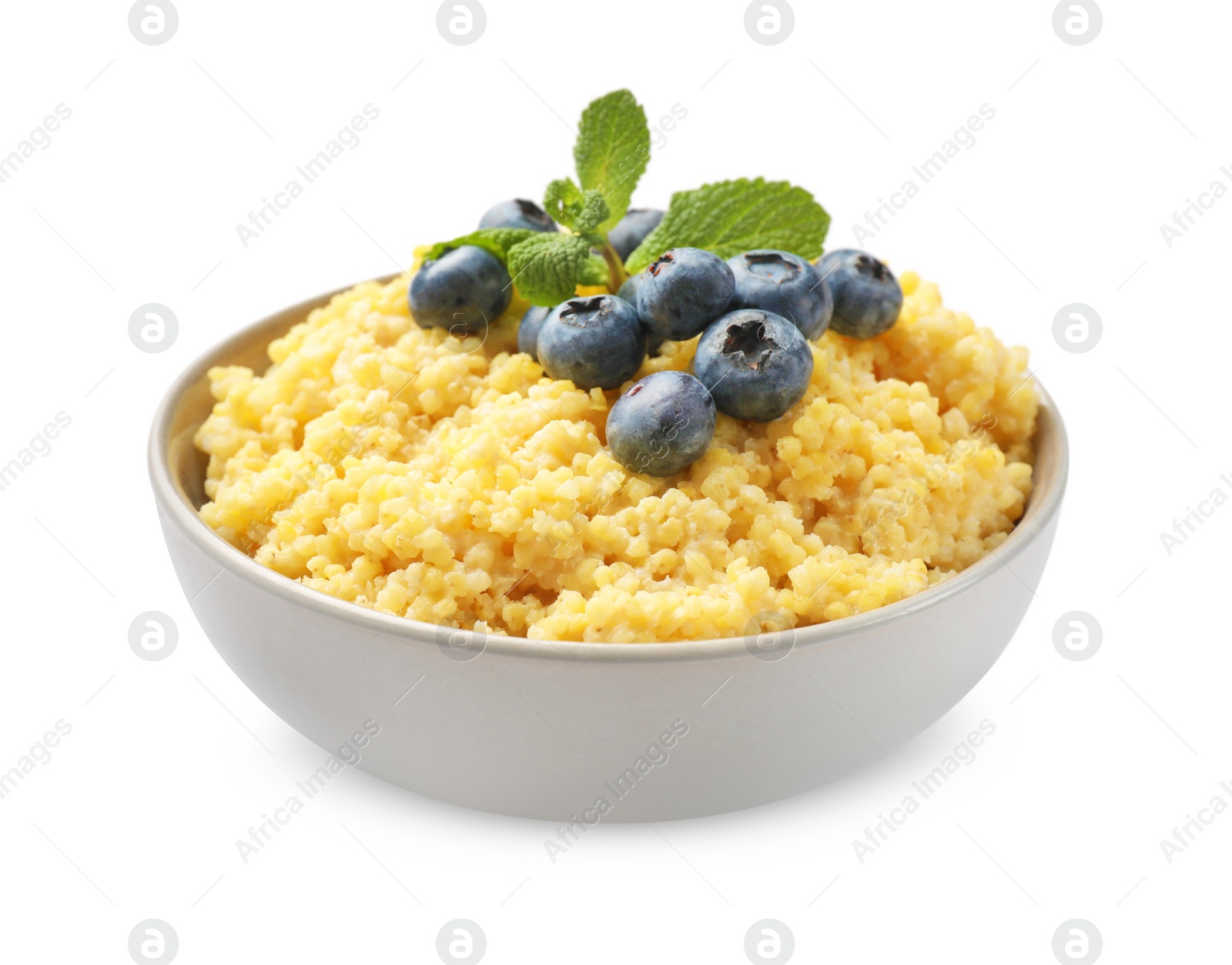 Photo of Tasty millet porridge with blueberries and mint in bowl isolated on white