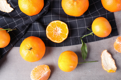Photo of Fresh ripe tangerines on grey table, flat lay