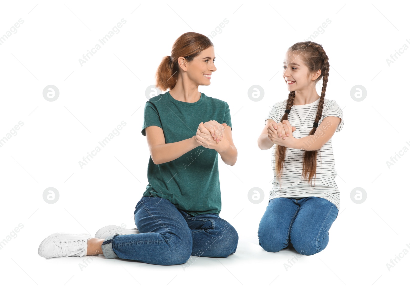 Photo of Hearing impaired mother and her child talking with help of sign language on white background