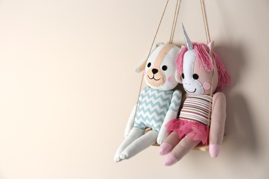Photo of Shelf with cute toys on beige wall, space for text. Child's room interior element