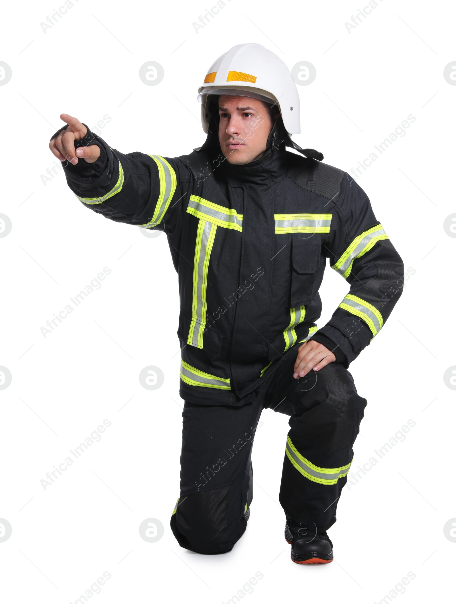 Photo of Full length portrait of firefighter in uniform and helmet on white background