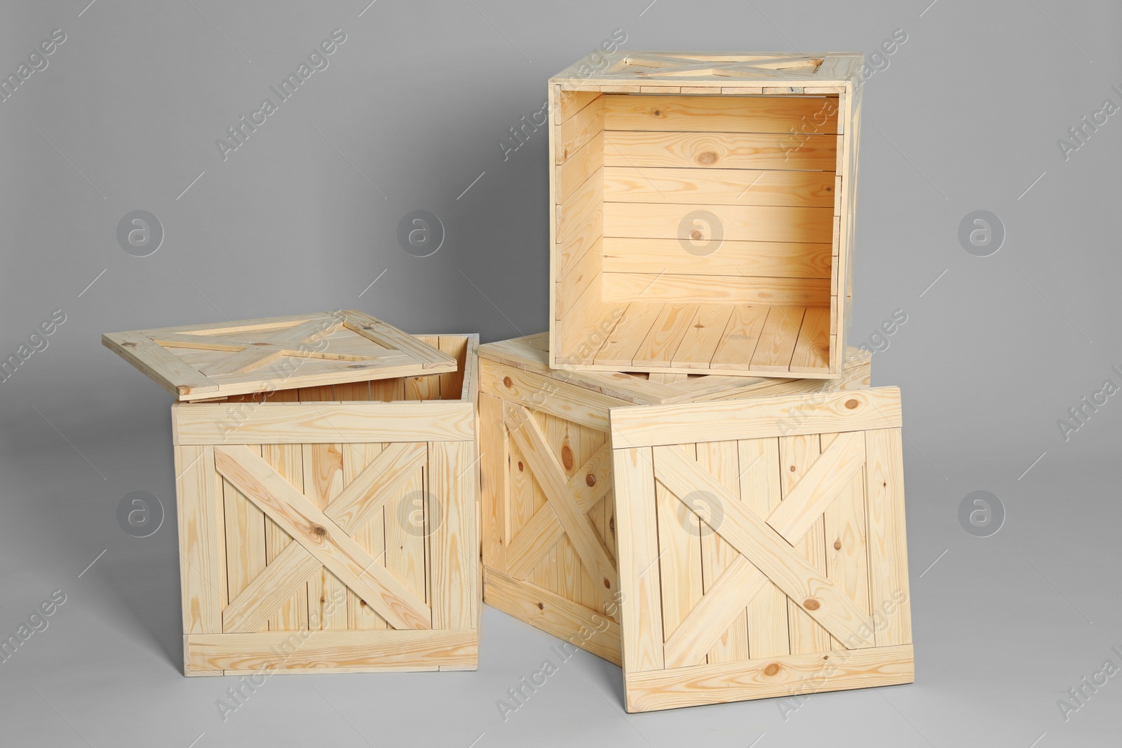 Photo of Group of wooden crates on grey background