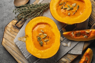 Photo of Flat lay composition with cream soup served in pumpkin on table